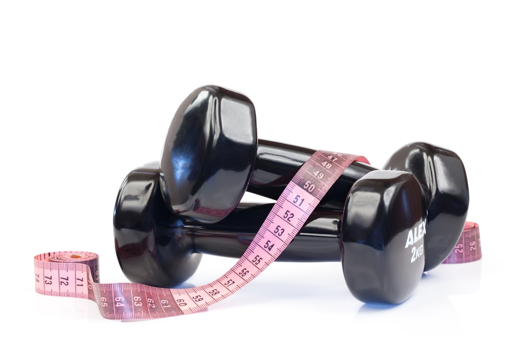 Measuring tape around waist showing weight loss progress