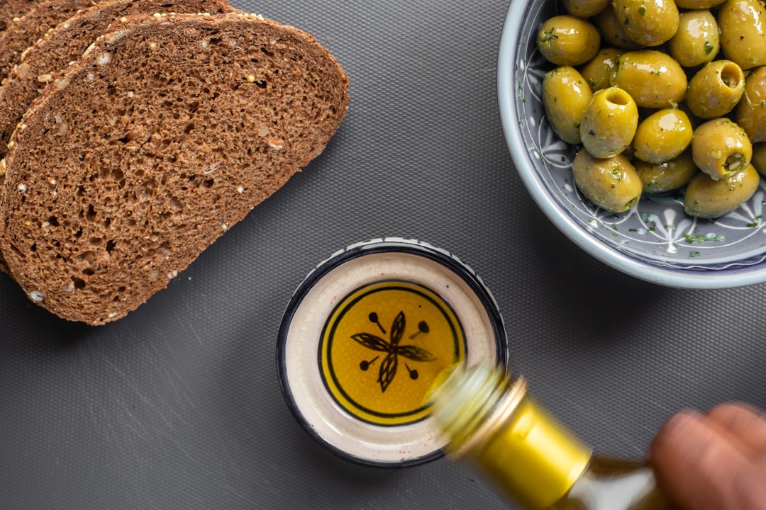 Olive oil being poured, rich in heart-healthy monounsaturated fats